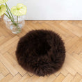 Bild in Galerie-Betrachter laden, Round handmade dog cushion with natural sheepskin filling, dark brown, on wooden floor.